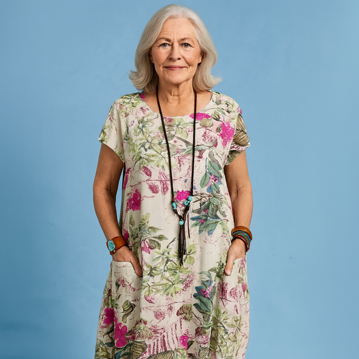 Casual women's floral midi dress for spring & summer. Features a beautiful print, short sleeves, & side pockets.