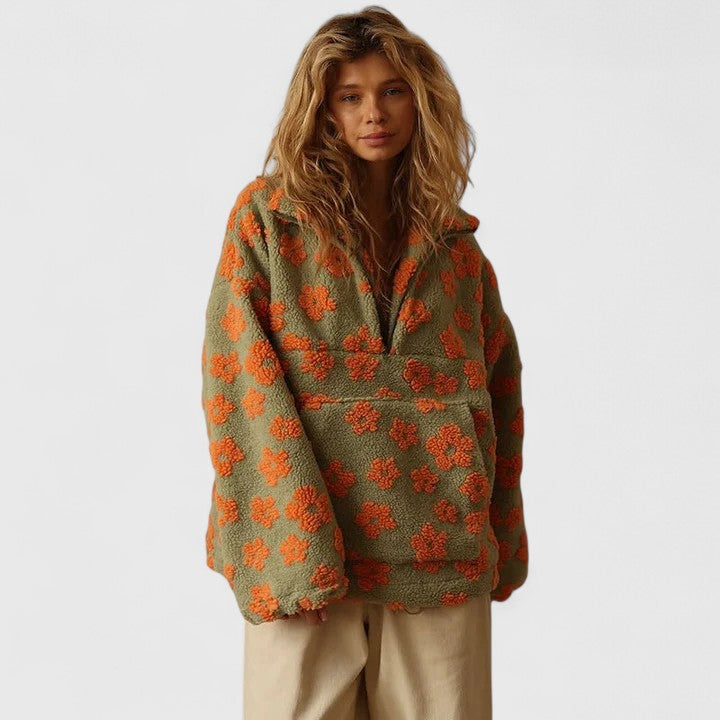 Stylish oversized women's pullover sweater with delicate floral print & quarter-zip detail.