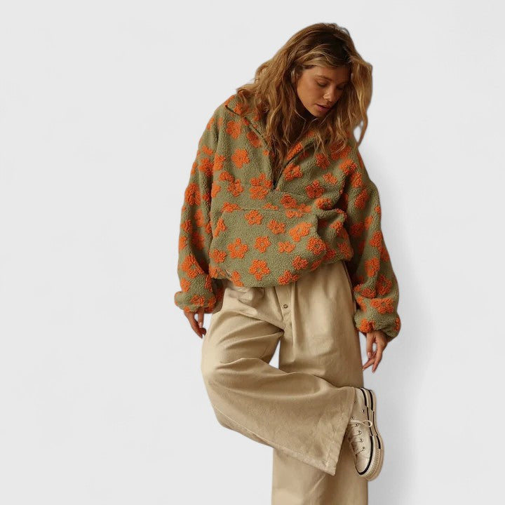 Women's quarter-zip pullover sweater showcasing a vibrant floral print, ideal for autumn.