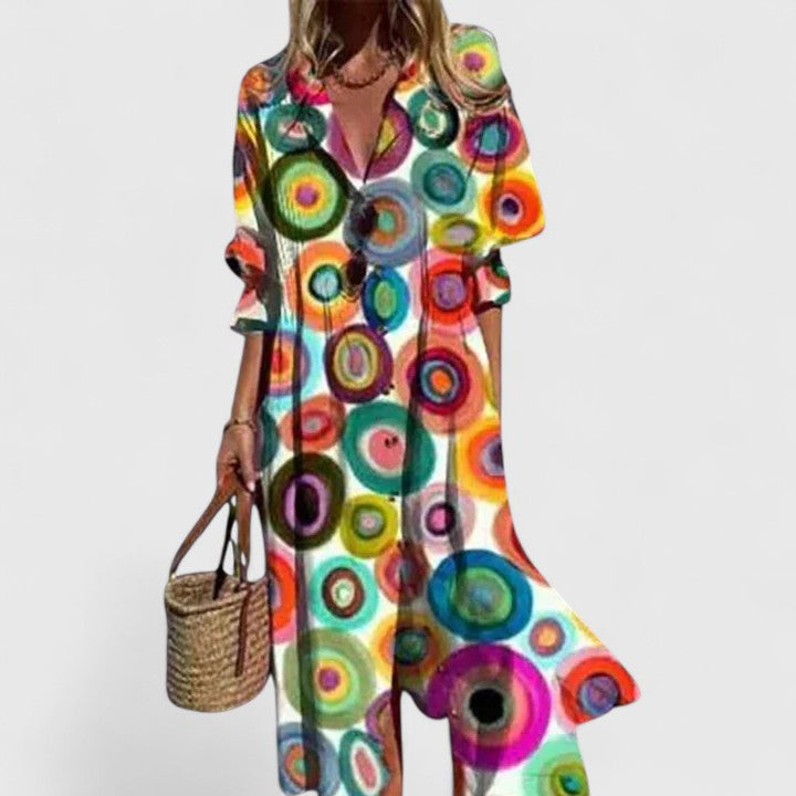 Woman in a flattering floral print midi shirtdress with pintuck pleats & collared V-neck. A comfortable summer fashion.