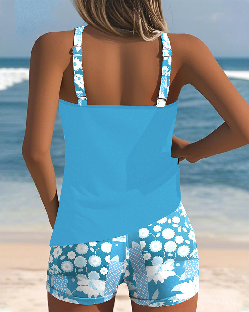 Women's floral tankini swimsuit with shorts, ready for summer swims, poolside relaxation & beach vacation.