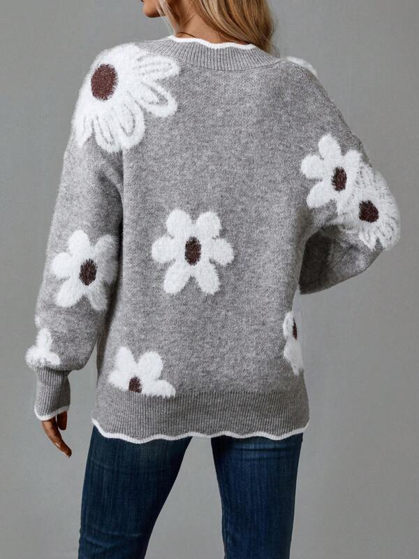 Close-up of a women's cozy V-neck jumper, showcasing the textured knit and delicate floral pattern.