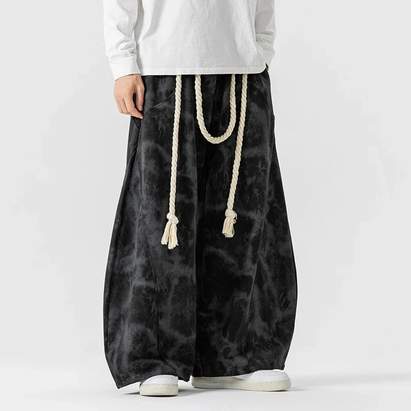 Versatile women's flowing wide-leg pants with a rope belt, ideal for stylish casual outfits.