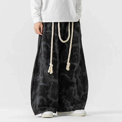 Versatile women's flowing wide-leg pants with a rope belt, ideal for stylish casual outfits.