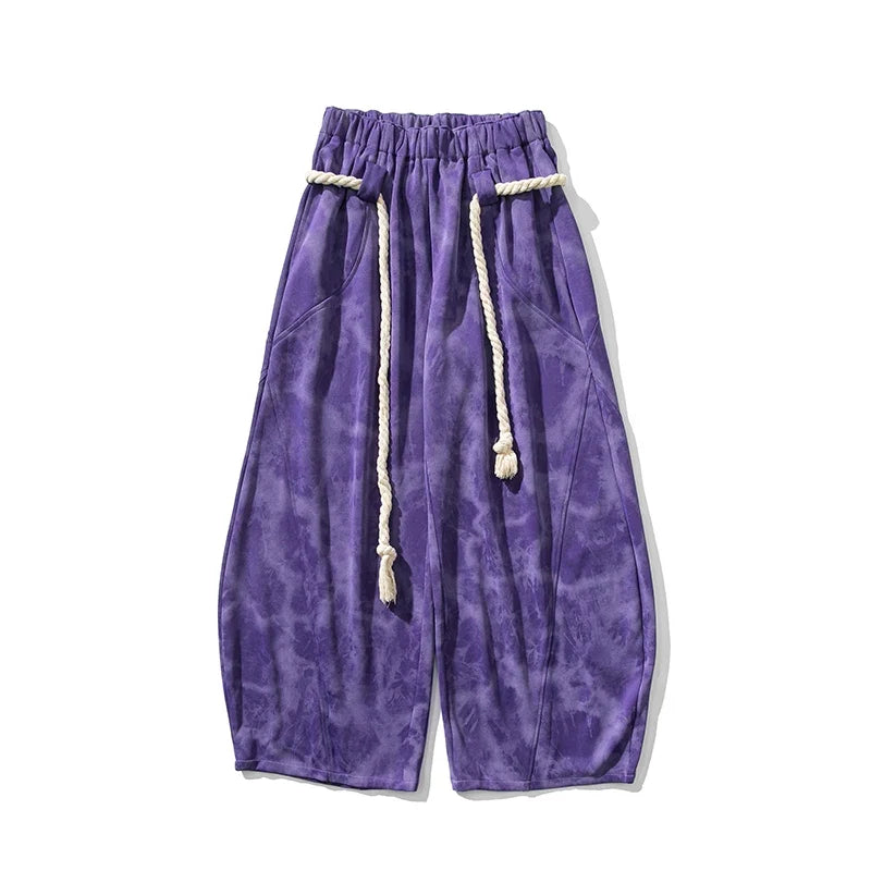 Elegant flowing wide-leg women's pants with a unique rope belt, offering a relaxed and stylish look.
