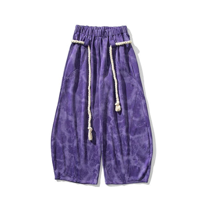 Elegant flowing wide-leg women's pants with a unique rope belt, offering a relaxed and stylish look.
