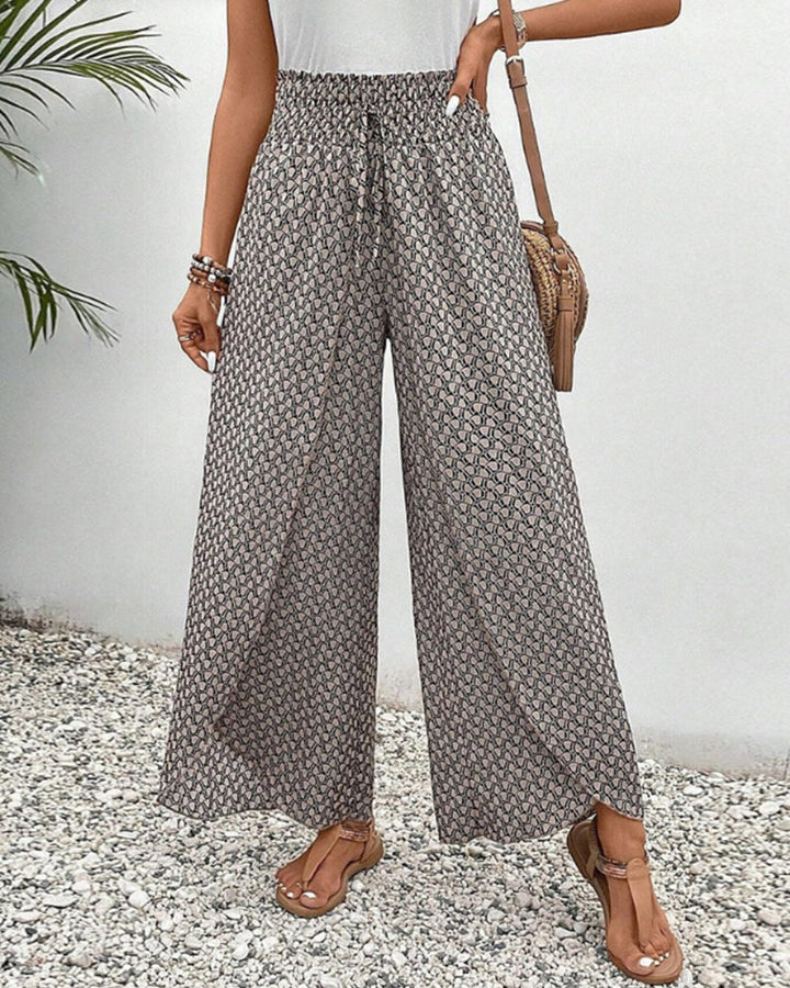 Women's flowing wide leg trousers with a relaxed fit, perfect for casual or evening wear.