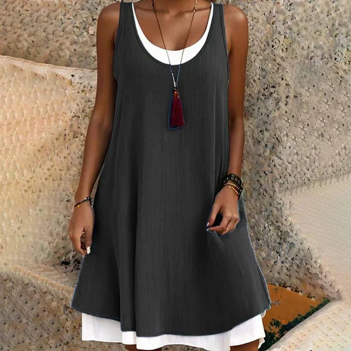 Women's flowy A-line mini dress with a scoop neck and layered design. Perfect for summer casual wear.