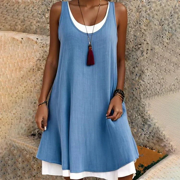 Sleeveless women's layered mini dress with a scoop neck, offering a flowy A-line silhouette for spring/summer style.