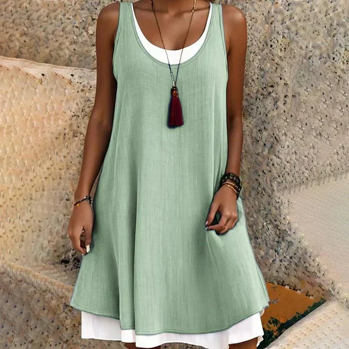 Versatile women's layered mini dress. Features a flattering scoop neck and flowy A-line design, ideal for summer outfits.