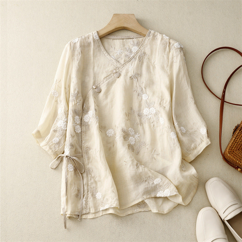 Women's flowy bohemian blouse with delicate floral embroidery, perfect for summer casual wear.