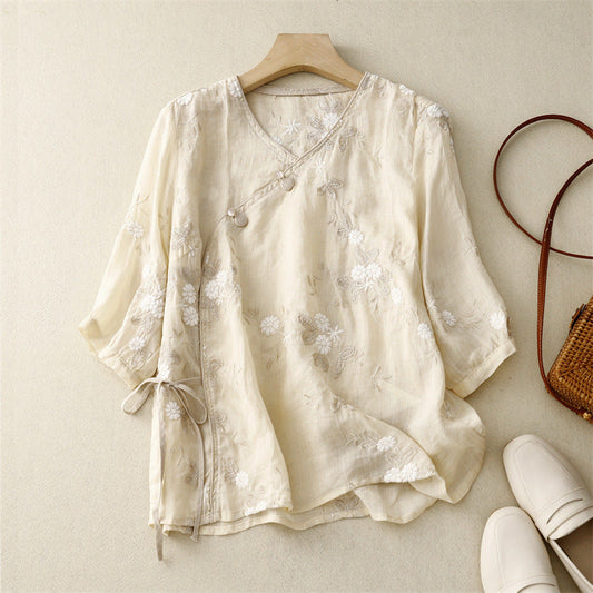 Women's flowy bohemian blouse with delicate floral embroidery, perfect for summer casual wear.