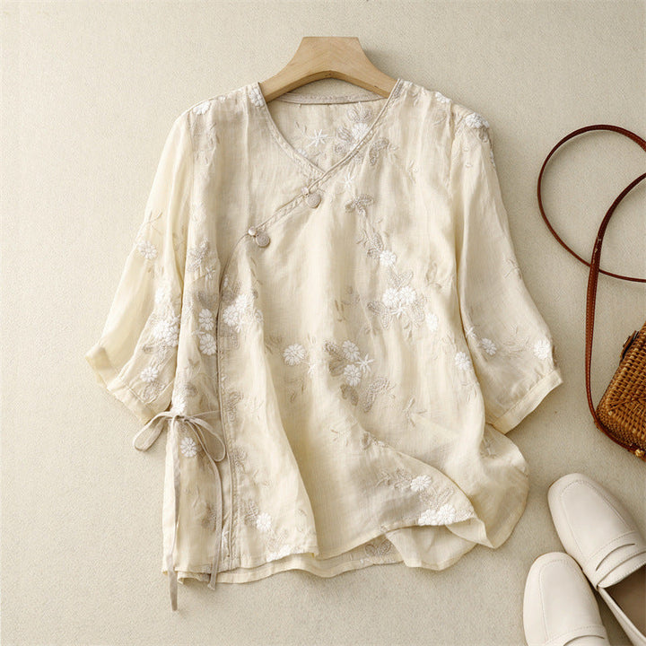 Women's flowy bohemian blouse with delicate floral embroidery, perfect for summer casual wear.