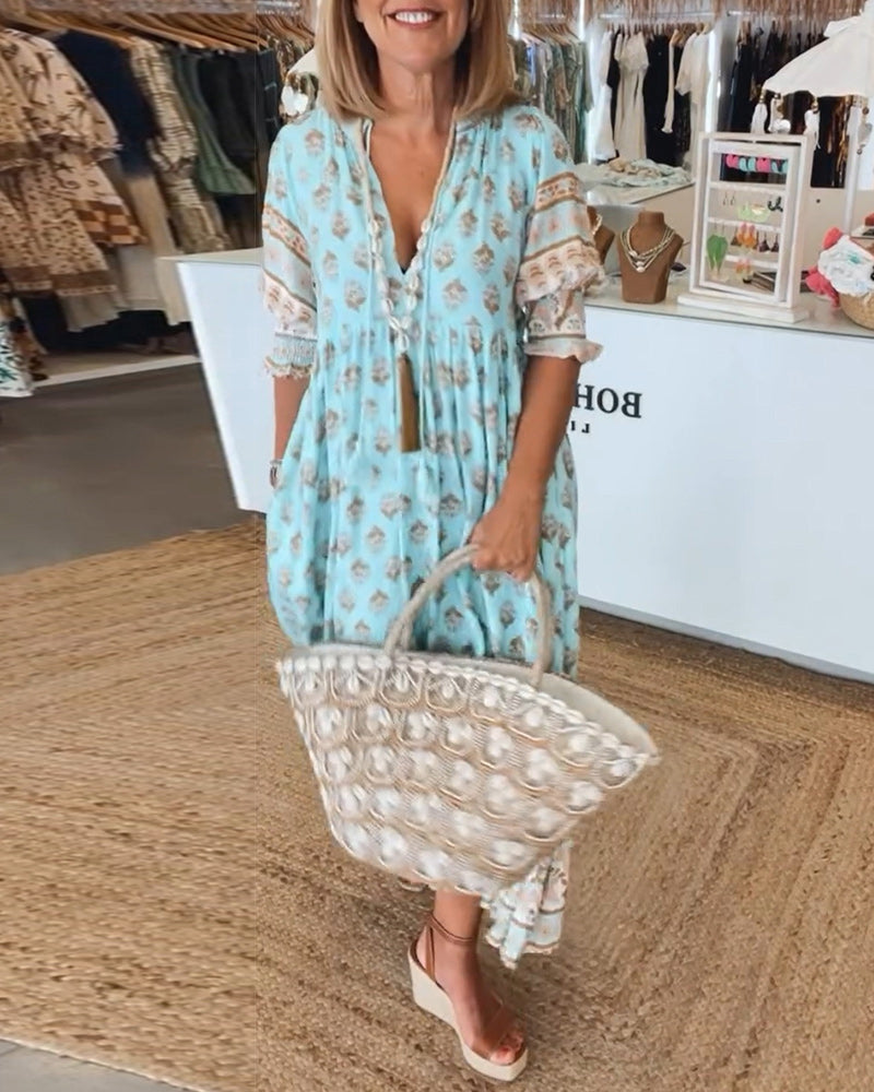 Women's flowy bohemian midi dress with convenient pockets, perfect for casual spring & summer comfort.
