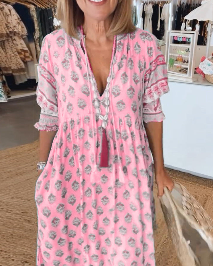 Casual women's summer midi dress, flowy bohemian design with practical pockets & V-neck detail.