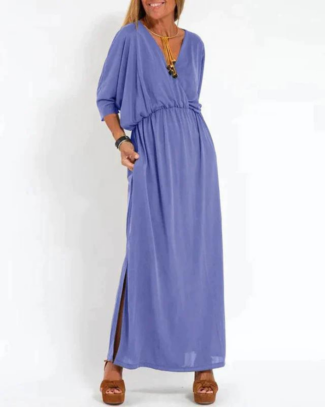Beautiful women's long flowy beach dress in a vibrant color, featuring comfortable adjustable shoulder straps for ease.