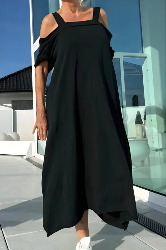 Women's flowy off-shoulder maxi summer dress. Elegant, airy beachwear for vacation.