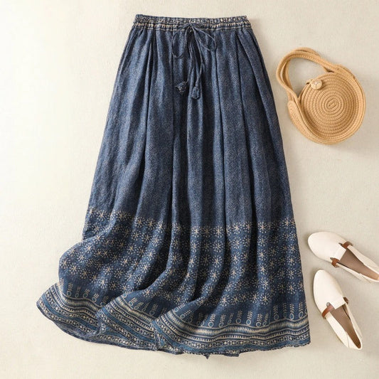 Women's flowy printed midi skirt with a comfortable drawstring waist, perfect for elegant casual summer wear.
