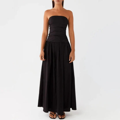 Women's flowy strapless maxi dress featuring a flattering ruched design, perfect for summer events.