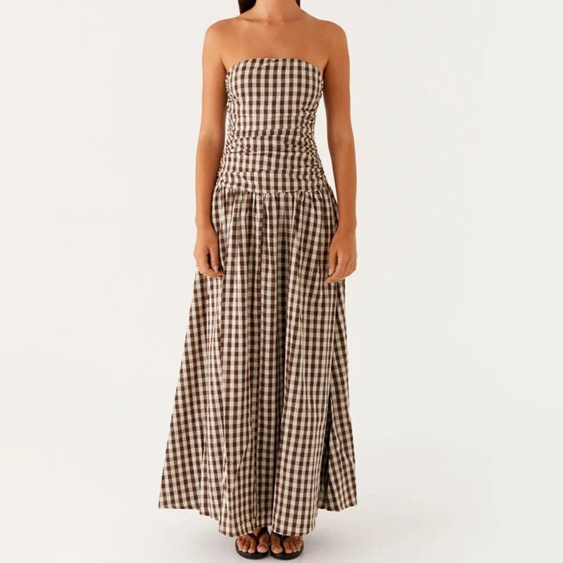Ruched strapless bodice on a women's flowy maxi dress, perfect for a stylish summer look.