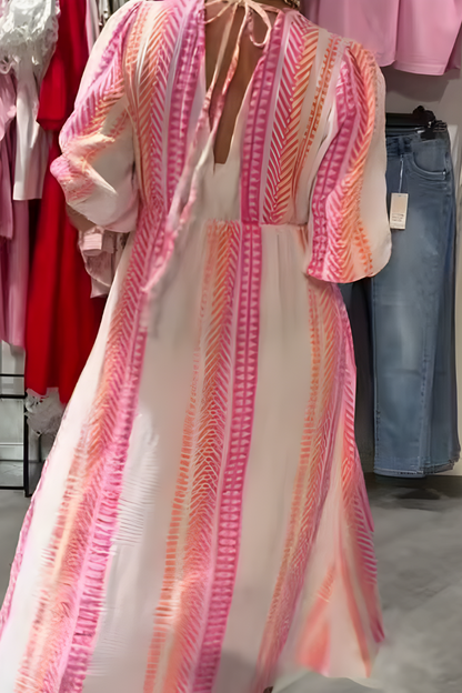 Pink women's pull-on flowy midi dress. Casual V-neck summer dress with flutter sleeves for breezy style.