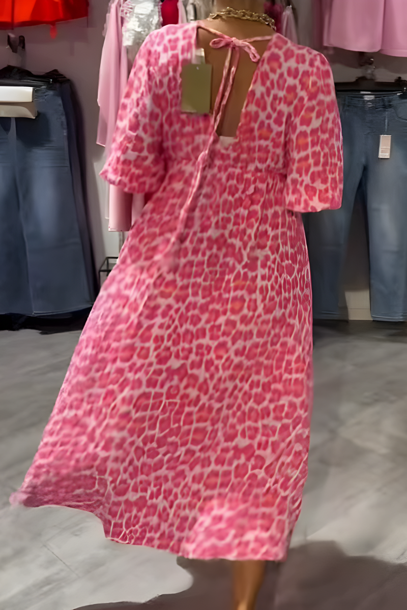 Stylish women's flowy summer day dress. Comfortable V-neck midi dress with flutter sleeves, great for vacation.