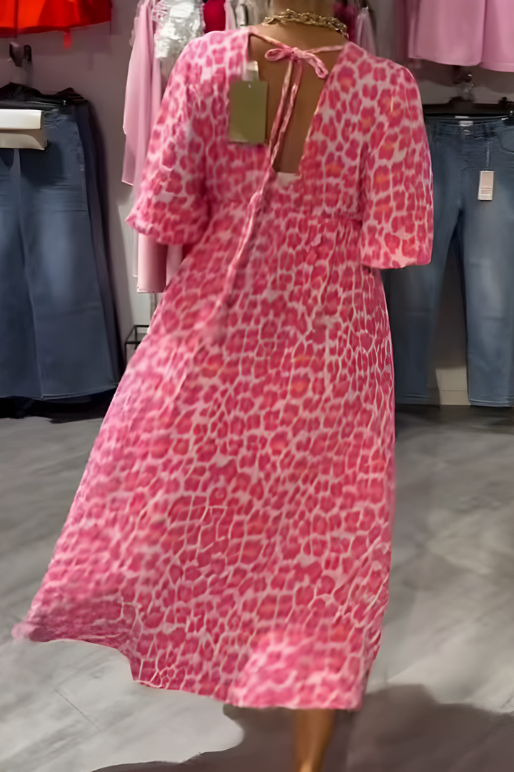 Stylish women's flowy summer day dress. Comfortable V-neck midi dress with flutter sleeves, great for vacation.