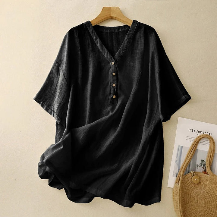 Elegant women's V-neck flowy blouse with half sleeves, a versatile black top for casual or dressed-up occasions.