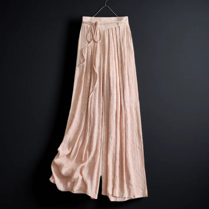 Women's flowy wide-leg summer pants with tie waist in a relaxed fit, perfect for casual vacation wear.