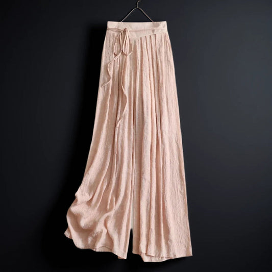 Women's flowy wide-leg summer pants with tie waist in a relaxed fit, perfect for casual vacation wear.