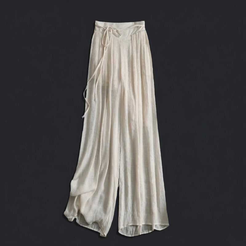Stylish women's high-waisted flowy wide-leg pants for summer. Features a comfortable relaxed fit and tie waist.