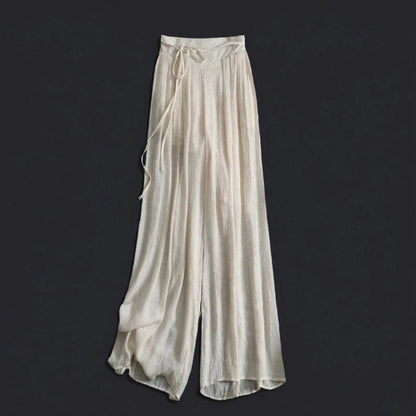 Stylish women's high-waisted flowy wide-leg pants for summer. Features a comfortable relaxed fit and tie waist.