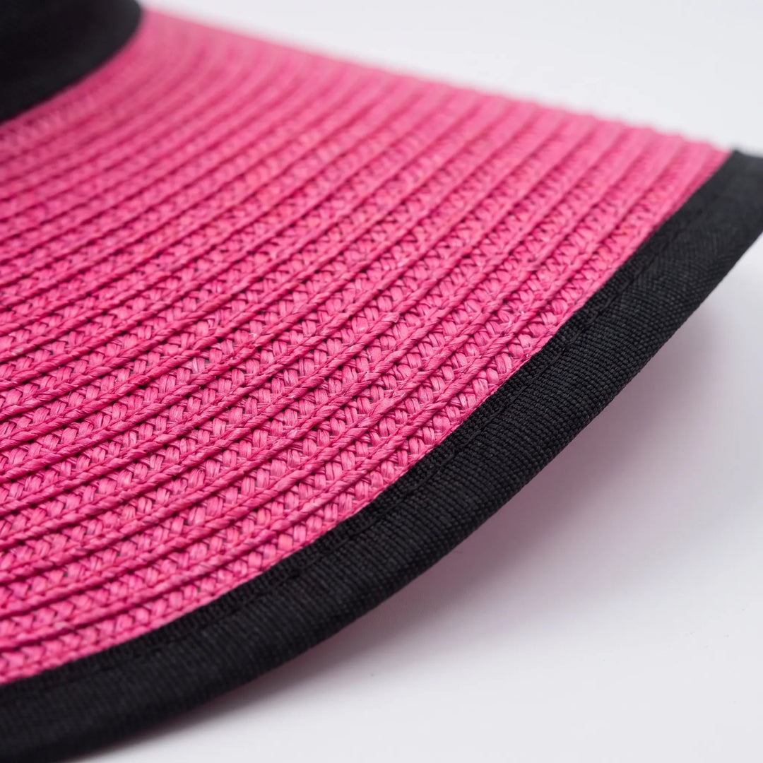 Chic pink women's wide brim floppy sun hat. Foldable design for easy packing, a stylish accessory for summer resort wear.