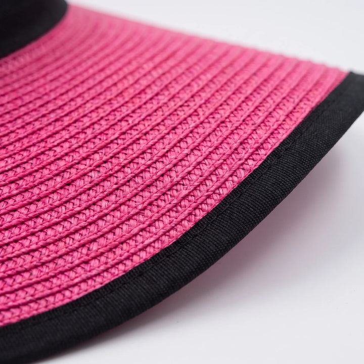 Chic pink women's wide brim floppy sun hat. Foldable design for easy packing, a stylish accessory for summer resort wear.