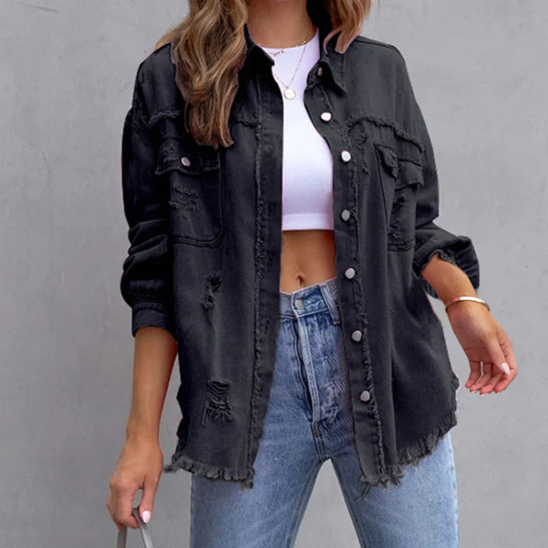 Modern women's distressed denim jacket with frayed accents, perfect for a trendy, casual fashion statement.