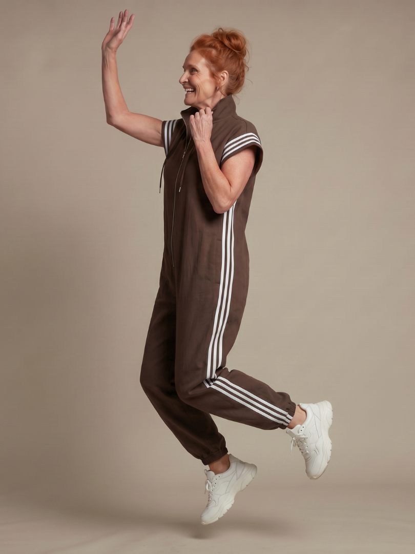 Women's casual full length jumpsuit with athletic side stripe & zip front.