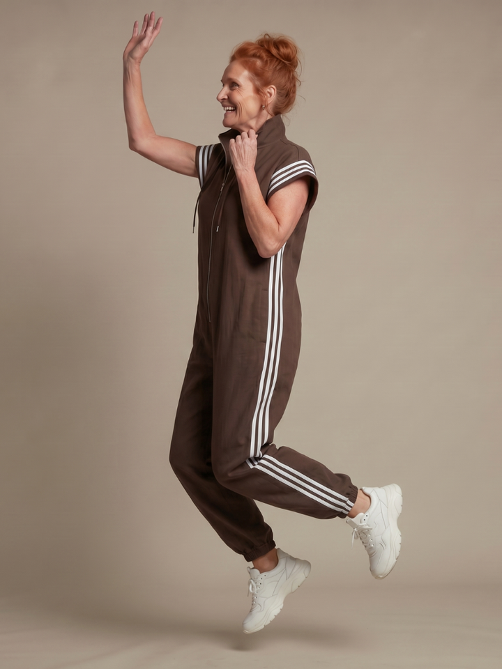 Women's casual full length jumpsuit with athletic side stripe & zip front.