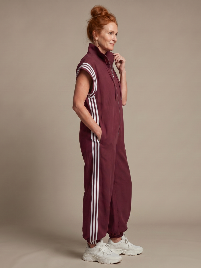 Sporty women's full length jumpsuit, zip front, side stripe & cap sleeves.