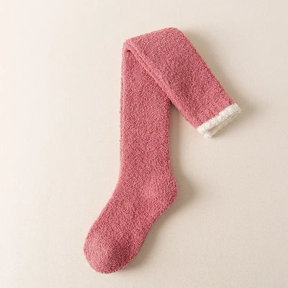Women's fuzzy knee-high socks in a cozy solid color, perfect for ultimate winter comfort and warmth.