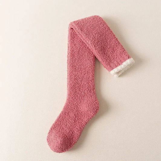 Women's fuzzy knee-high socks in a cozy solid color, perfect for ultimate winter comfort and warmth.