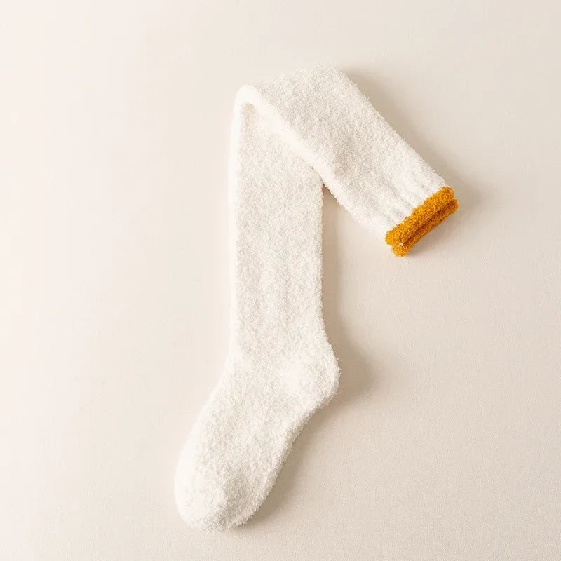 Soft, plush fuzzy knee-high socks for women, providing warmth and comfort as essential winter loungewear.
