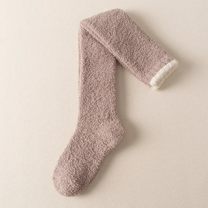 Warm women's fuzzy knee-high socks, ideal winter accessories for cozy lounging and ultimate comfort.