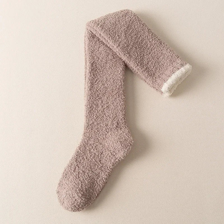Warm women's fuzzy knee-high socks, ideal winter accessories for cozy lounging and ultimate comfort.