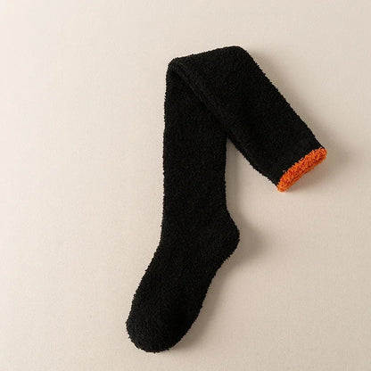 Vibrant rose red fuzzy knee-high socks for women, offering luxurious softness and ultimate winter comfort.