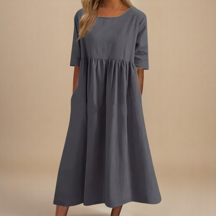 Casual women's midi dress with a scoop neck & half-sleeves, flattering gathered waist detail.