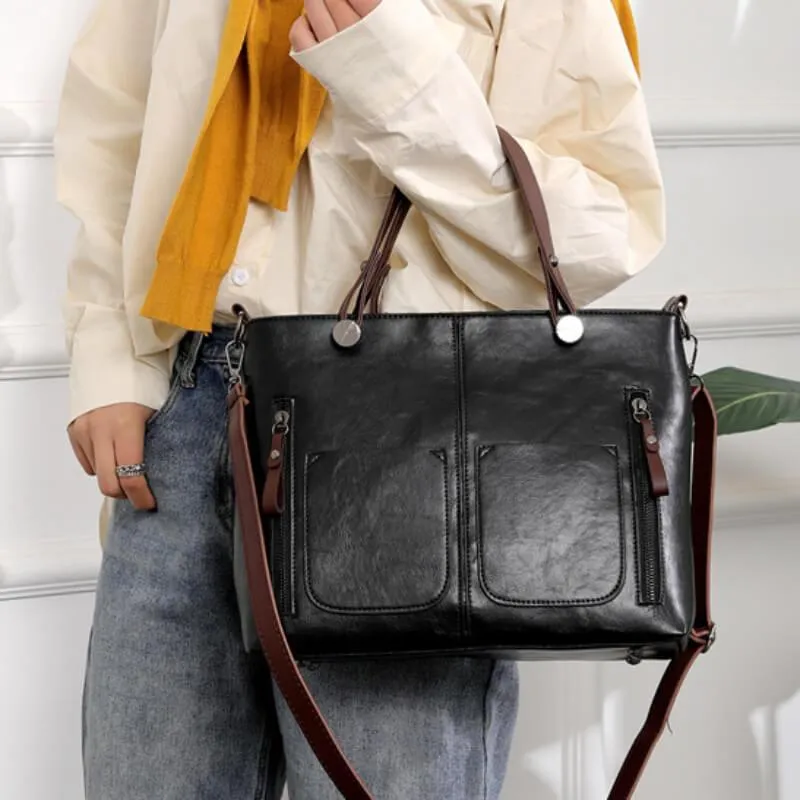 Durable women's leather handbag in gray, an elegant everyday shoulder bag with adjustable strap.