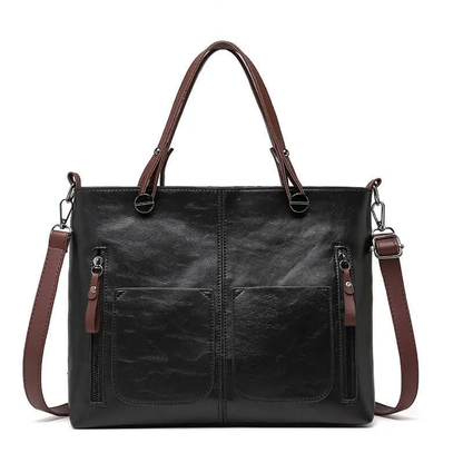 Classic brown women's durable leather handbag. Versatile as a shoulder or crossbody bag with adjustable strap.