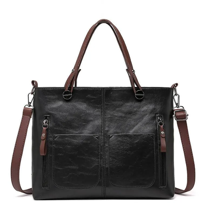 Classic brown women's durable leather handbag. Versatile as a shoulder or crossbody bag with adjustable strap.