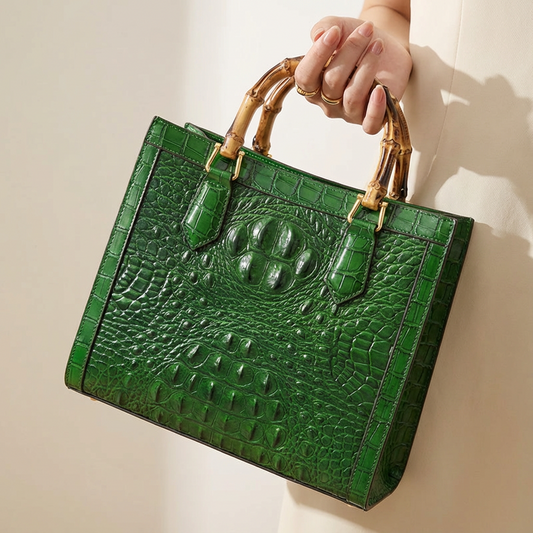 Women's genuine leather handbag with elegant crocodile pattern & unique bamboo handle. Luxury fashion accessory.