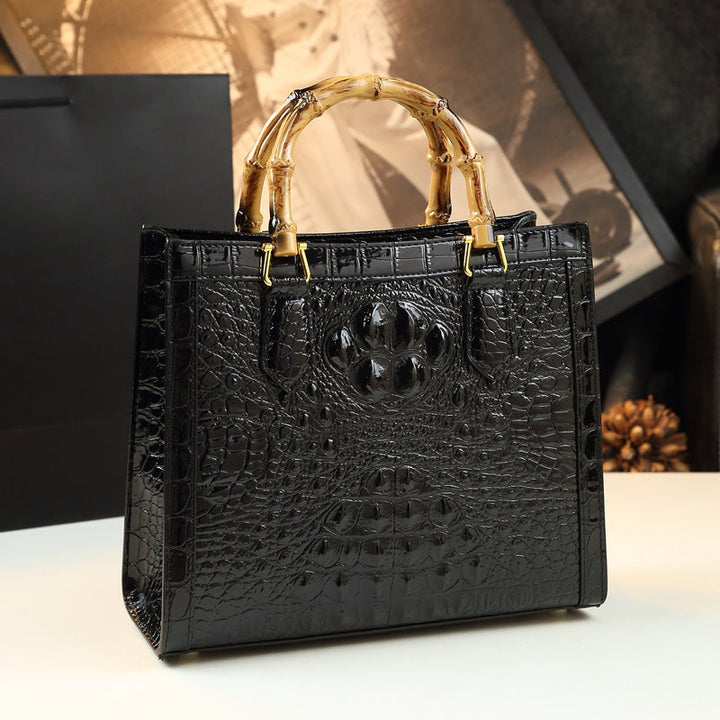 Premium women's handbag: genuine leather, exotic crocodile texture, and stylish bamboo handle.